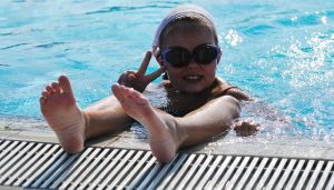 Child having fun in pool on staycation