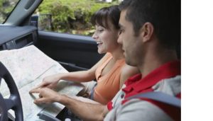 Couple pointing at map. Take a drive on your staycation.