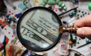 Magnifying glass over cash.