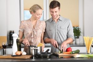 Man and woman cooking. Date night ideas for any budget.