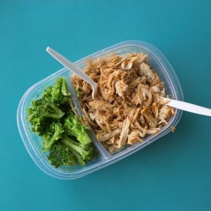 Chicken, rice and broccoli in a plastic container. How to avoid buying lunch at work